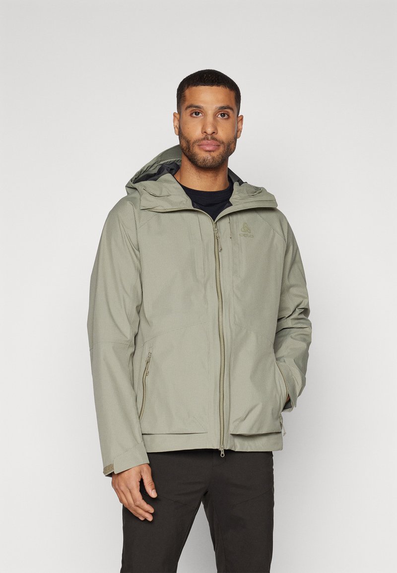 Light green waterproof jacket with a hood, featuring a grid pattern, zip pockets, and adjustable cuffs for secure fit.