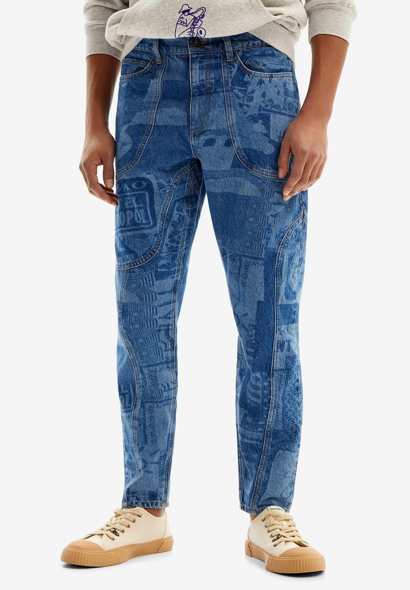 Blue denim jeans featuring a textured pattern with light and dark shades. Five-pocket design with a straight fit, paired with light sneakers.