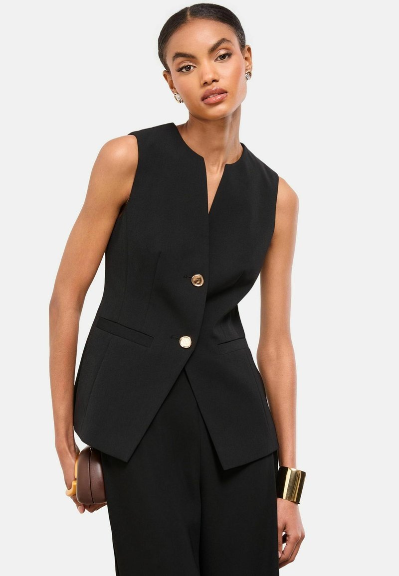 Schwarzer ärmelloser Blazer mit V-Ausschnitt, zwei vorderen Taschen und einem Doppelknopfverschluss mit goldenen Beschlägen. Maßgeschneiderte Passform, elegantes Design.