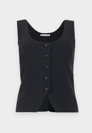 Melns pieguļošs veste bez piedurknēm ar apaļu izgriezumu un piecām pogām priekšpusē, apakšmalā ar vieglu V-veida izgriezumu.