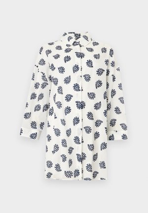 Camisa blanca de manga larga con botones, con patrón de hojas paisley en azul marino, cuello puntiagudo y dobladillo recto sobre un fondo liso.