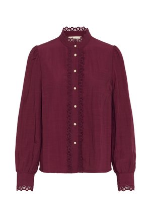Burgundy long-sleeve blouse with a high collar, lace trim, and button closure. Features puffed sleeves and scalloped cuffs.