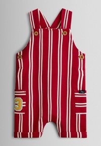 Czerwono-biały pasiasty kombinezon dla malucha z drewnianymi guzikami na ramiączkach i bokach, z dwoma bocznymi kieszeniami, jedna z kolorową naszywką z cyfrą "3".