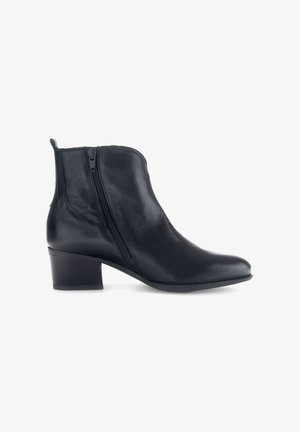 Black leather ankle boots with a smooth finish, round toe, low block heel, and side zipper for ease of wear. Minimalist design.