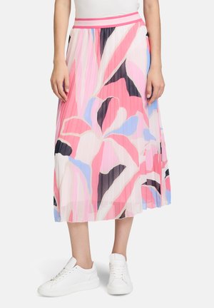 Pleated midi skirt in lightweight fabric featuring a pink and blue floral pattern, with a contrasting pink waistband. Worn with white sneakers.