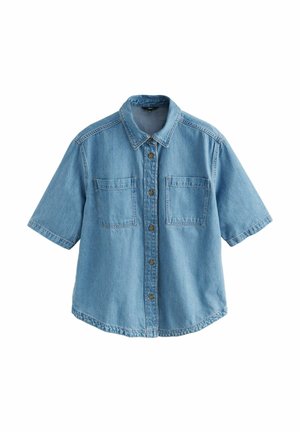 Világoskék, rövid ujjú farmering klasszikus gallérral, két elülső zsebbel és barna gombzárral. Lazább szabású, ívelt alsó szegéllyel rendelkezik.