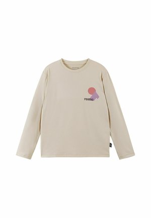 Camicia beige a maniche lunghe con scollo tondo, con un piccolo logo geometrico rosa e viola e il testo "reima" sul petto.