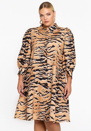 Korte mouw jurk in beige met zwart-wit tijgerstreep patroon, voorzien van een knoopsluiting aan de voorzijde en verzamelde mouwen voor volume.