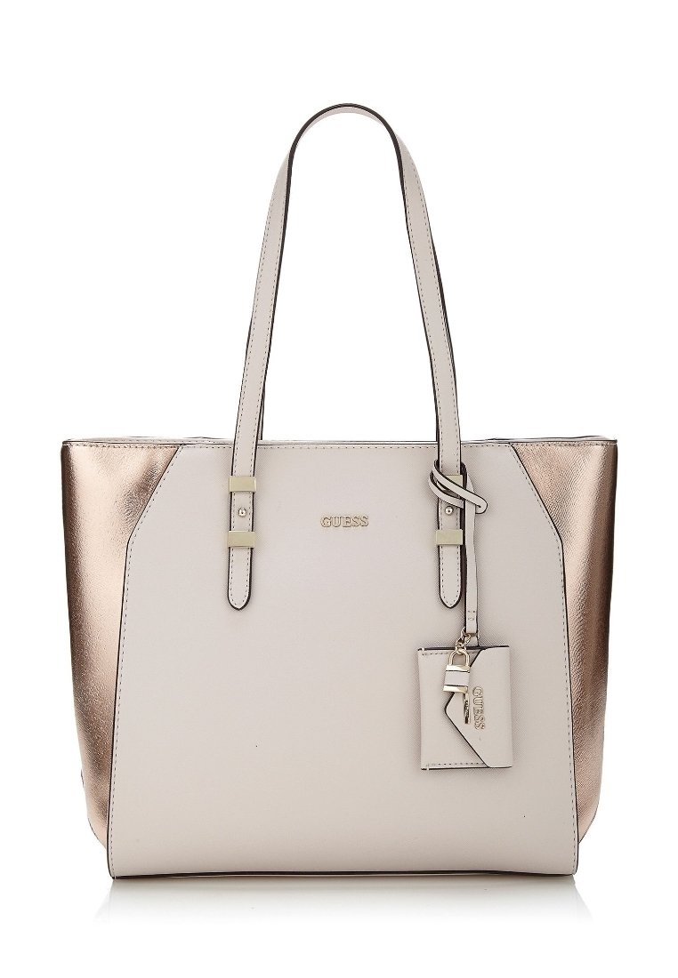 Kangaskassi, jossa on vaaleanbeige etuosa ja metallinhohtoiset rose gold -sivut, kaksinkertaiset olkahihnat ja pieni kiinnitetty tagi avainkoristeella.