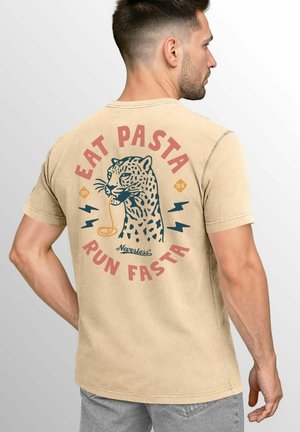Beige cotton t-shirt featuring a leopard illustration with "EAT PASTA RUN FASTA" text in red and blue, rounded lettering, and lightning accents.