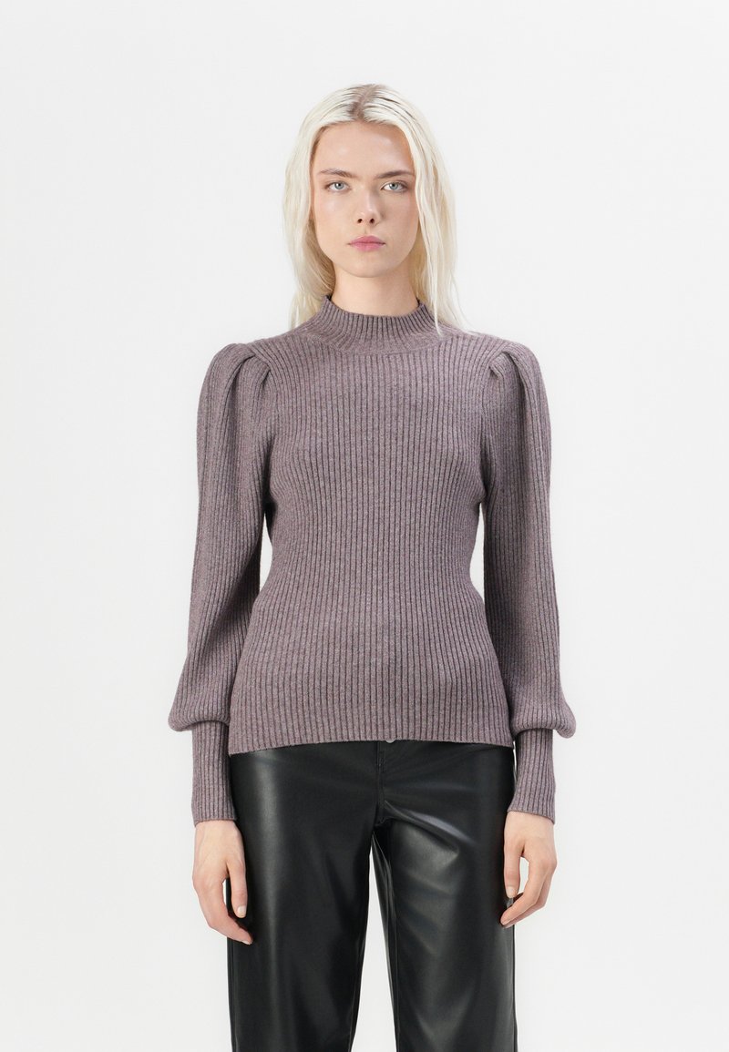 Light purple ribbed knit sweater with a high neckline and puffed long sleeves, paired with black leather pants.
