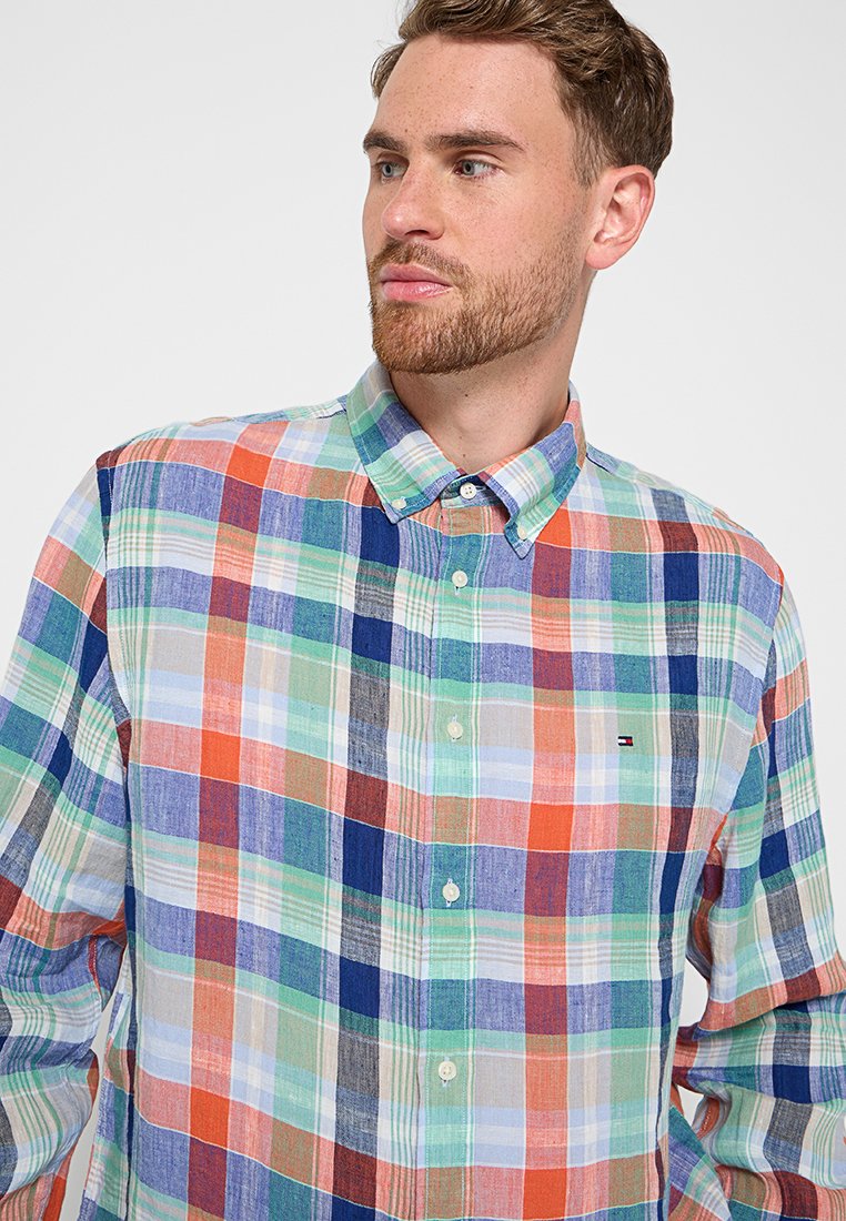 Baumwollhemd mit knöpfbarem Kragen und einem mehrfarbigen Karomuster aus blauen, grünen, orangen und roten Quadraten; mit Spitzkragen und Brustlogo.