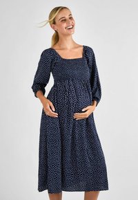 Laivansinisillä pilkullisella mekolla on neliön muotoinen pääntie, pitkät hihat ja kerätty vyötärö. Mekko on suunniteltu rentoon istuvuuteen. Silkkinen kangas.