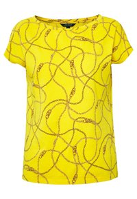 Gul kortärmad T-shirt med ett kedjemönster i bruna nyanser, rund halsringning och avslappnad passform. Mjuk tygkänsla.