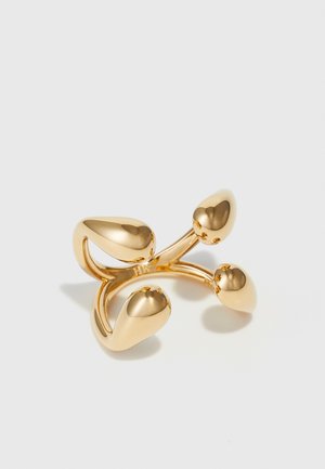 Gold ring featuring a curved design with four teardrop-shaped accents. Smooth, reflective surface; lightweight and modern aesthetic.
