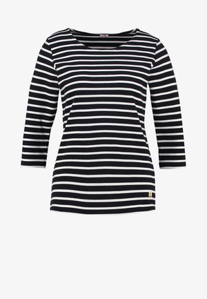 Czarna i biała, w paski, długosleeve'owa koszula z dekoltem w serek, z małym złotym emblematem kotwicy na dolnym lewym boku.