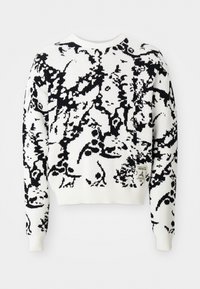 White sweater with a black abstract pattern, ribbed cuffs and hem, round neckline, and a small logo patch on the bottom left side.