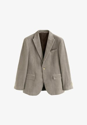 Világosbarna kordbársony blézer, két elülső zsebbel, zsebkendővel és aranyszínű gombokkal az ujjakon. Texturált, testhez simuló fazon.