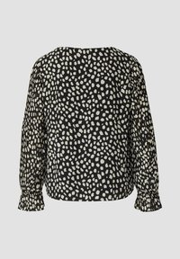Schwarze Bluse mit abstrakten weißen Punkten, langen Puffärmeln und gerafften Manschetten. Weiches Gewebe mit einem strukturierten Muster über die gesamte Fläche.