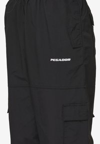 Pegador YURI TRACKSUIT PANTS - Tracksuit bottoms - black