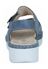 Blue back view of a sandal with a textured upper, adjustable strap, and a white platform sole. Soft interior lining visible.