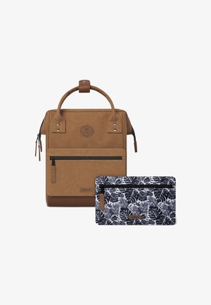 Brown faux leather backpack with top handle, front zip pocket, and logo detail, alongside a smaller black and white leaf-patterned pouch.