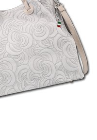 Light gray handbag with embossed swirling circular patterns, beige leather straps, and a small charm featuring the Italian flag colors.