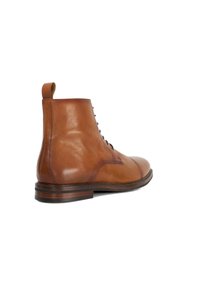 Brown leather ankle boots with a smooth finish, round toe, and lace-up front. Features a pull tab at the back and a stacked heel.