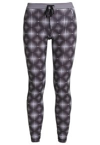 Leggings neri con un motivo a pois bianchi. Dotati di una vita elasticizzata con cordino e tessuto liscio e stretch per il massimo comfort.