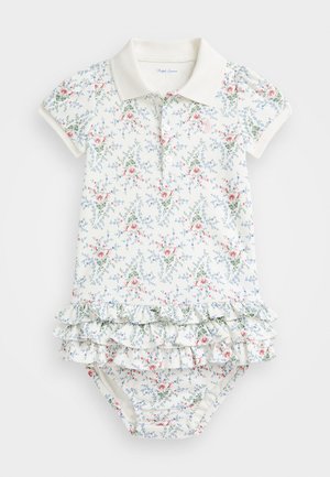 Krémové polo body s kvetinovým vzorom a volánovým lemom. Má krátke rukávy, zapínanie na gombíky a potlač ružových a modrých kvetov na zelených stonkách.