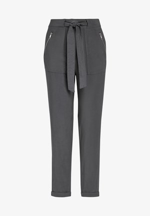 Pantalon gris avec taille à nouer, ourlets retroussés et poches avant zippées. En tissu lisse avec une coupe décontractée.