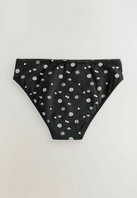 Zwart bikini-onderdeel gemaakt van soepele stof, met een verspreid wit bloemenpatroon. Elastische tailleband en volledige bedekkende ontwerp.