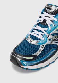 Close-up of a blue and black Saucony running shoe with white laces and mesh fabric upper on a white background.