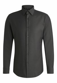 Chemise noire à manches longues en tissu texturé, avec un col boutonné, des boutons sur le devant et des poignets à boutons.