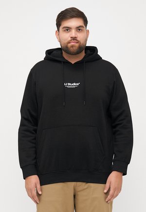 Black hoodie made of cotton, featuring a front pocket, drawstring hood, and white "JJ Studios" logo in the center. Soft texture, casual fit.