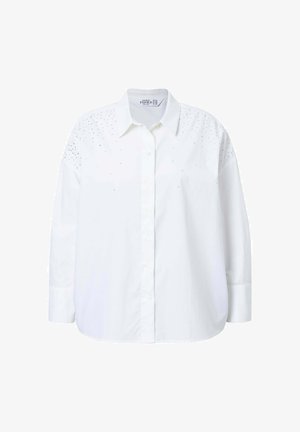 Hvid bomulds skjorte med knaplukning foran, spids krave og lange ærmer. Har spredte rhinsten på skuldrene som dekoration.