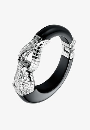 Pulsera bangle negra con textura pulida, presenta acentos de tono plateado con escamas y garras detalladas, incluye un mecanismo de cierre.