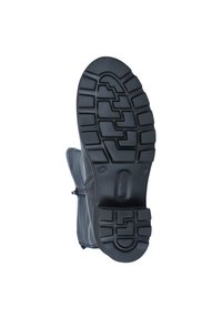 Semelle en caoutchouc noir d'une botte avec un motif de texture et de semelle. La partie supérieure est en tissu gris avec une fermeture à glissière sur le côté.