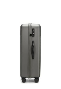 Hard-shell grey suitcase with a textured surface, black zipper, and built-in combination lock. Four wheels for easy maneuverability.