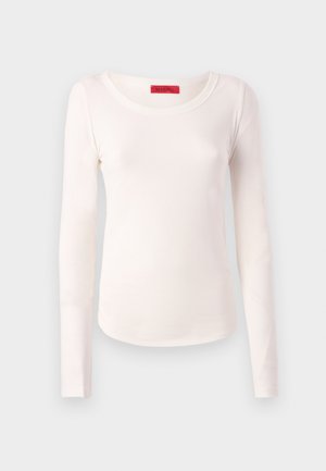 Long-sleeve top in soft, lightweight, off-white fabric. Features a rounded neckline and a fitted shape with minimal stitching details.