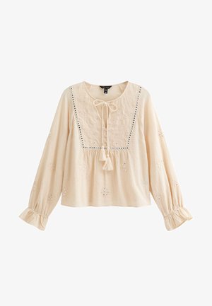 Kremowa bluzka z długimi rękawami, haftowanymi detalami, okrągłym dekoltem, sznurkiem do wiązania i frędzlami. Zbiera się w talii.