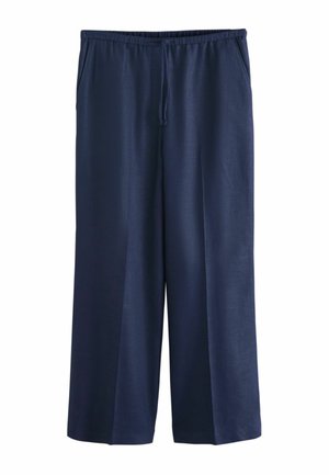 Tumši zili plašas bikses ar elastīgu jostu un auklu, priekšējām kabatām un gludu auduma tekstūru.