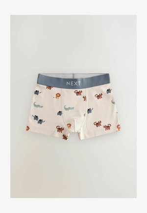 Dečija donji veš u krem pamuku s plavim pojasom na kojem je naljepnica "NEXT"; ukrašen šarenim životinjama uključujući lavove, slonove i krokodile.