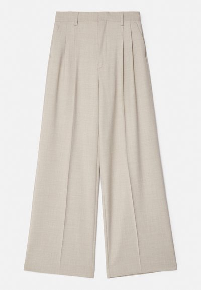 Béžové široké nohavice s hladkou textúrou, so skladanými prednými časťami, plochým pásom a upraveným strihom pre voľnejší fit.