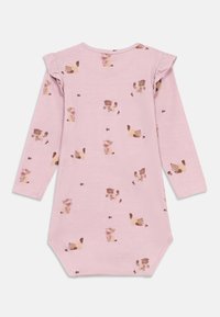 Light pink long-sleeve dress featuring a repeating pattern of small brown animals with bow accents. Soft cotton material with ruffle sleeves.