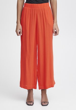Weite Hosen in leuchtendem Orange, aus leichtem Stoff mit strukturiertem Finish. Elastischer Bund und gesäumte Kanten.