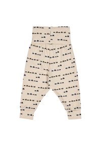 Beżowe bawełniane legginsy z wzorem kolorowych ciężarówek. Posiadają elastyczny pas i ściągacze przy nogawkach.