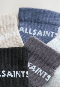 Štiri para rebrastih pletenih nogavic v črni, bež, sivi in modri barvi, vsak par z belim napisom "ALLSAINTS" na manšeti.