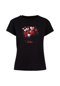 Black cotton t-shirt featuring a colorful heart graphic in red and pink with a "Be mine" text, short sleeves and a classic fit.
