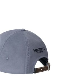 Gorra de béisbol azul claro con "Hackett London" bordado en la parte trasera y correa ajustable de cuero marrón con hebilla de metal.